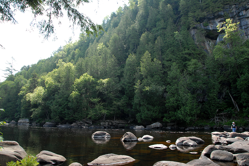 The massive scale of the rive aqt Blue Ledge is conveyed by the small figure in the lower right corner